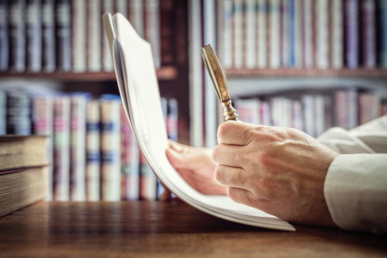CaseGuard-businessman-or-attorney-with-magnifying-glass-read
