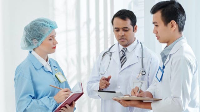 Doctors talking about a file