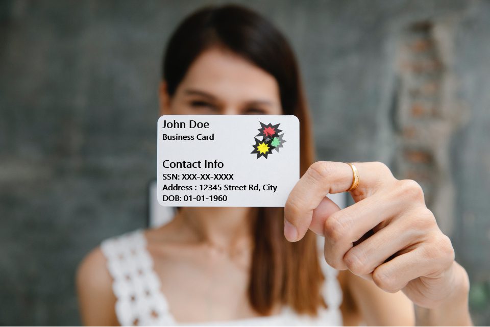 Woman holding a card with sensitive information on it