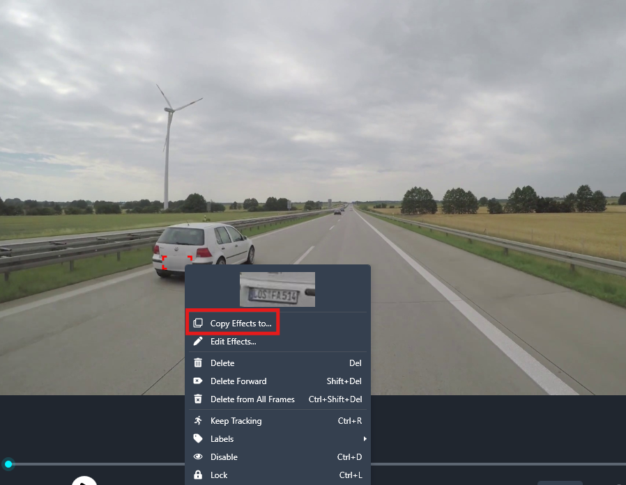 Highway scene with a white car on the left, wind turbine in the distance, and a video editor menu reading 'Copy Effects to…' in the foreground.