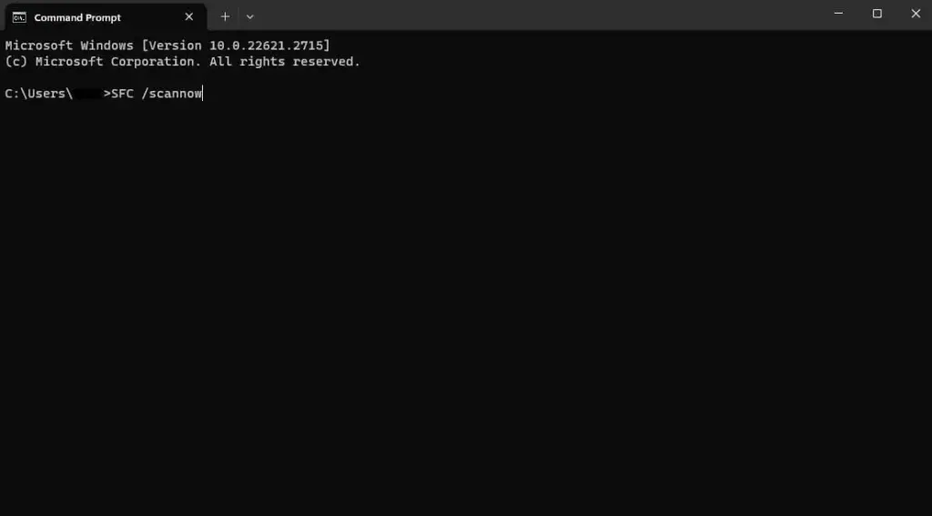 Windows Command Prompt showing the command 'SFC /scannow' ready to scan system files in a black terminal.