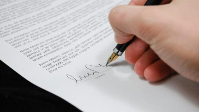 Man signing document